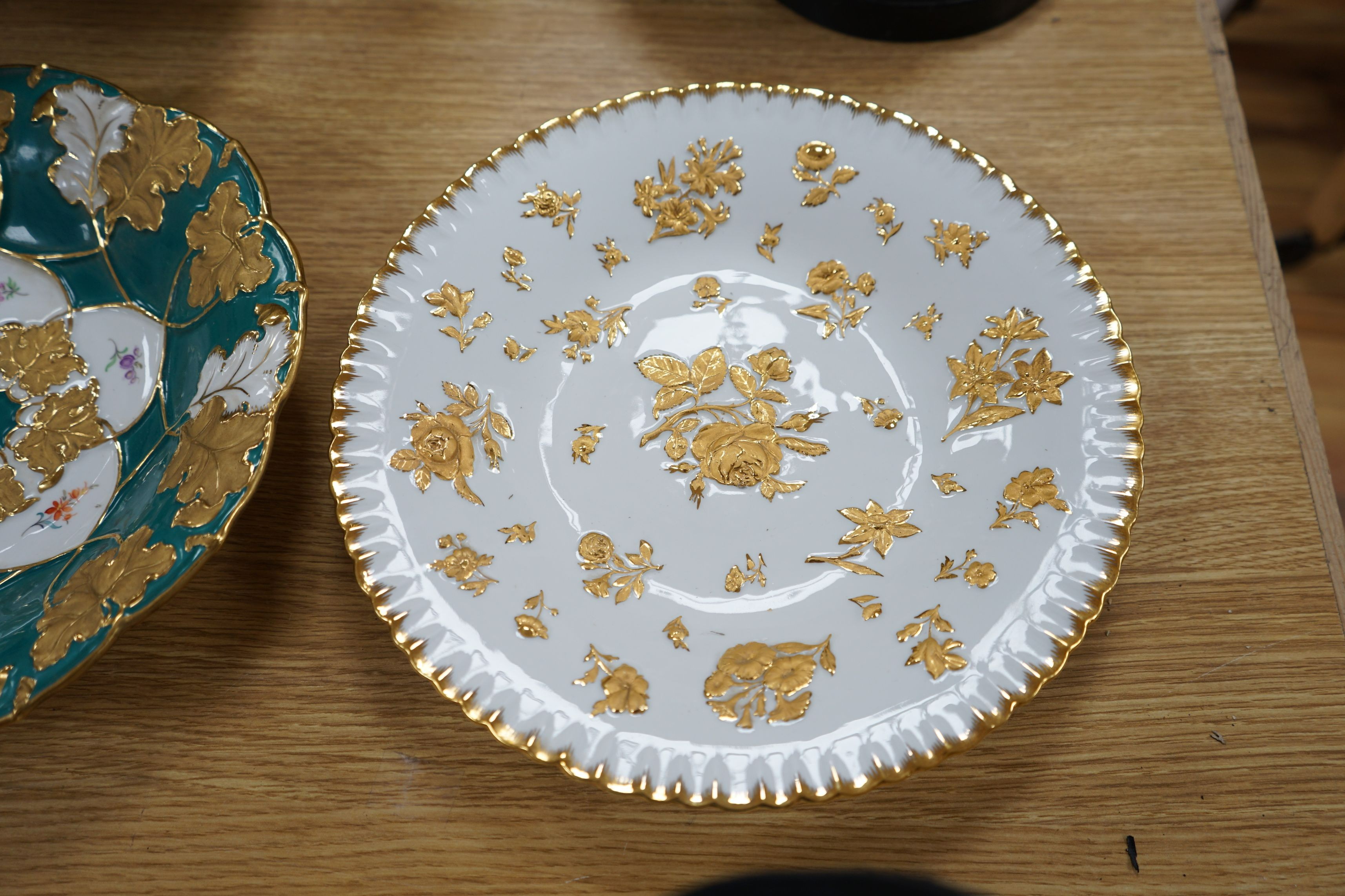 Two Meissen floral and gilt dishes and another shallower dish, 28cms diameter (3)